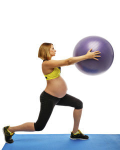 Beautiful pregnant woman doing exercises with fitball on white background