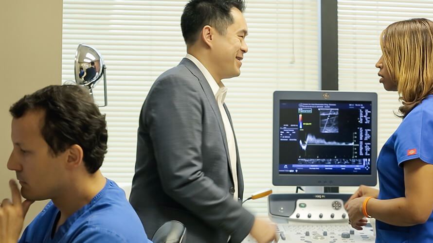 Dr Nguyen as he reviews a one month post procedure follow up scan